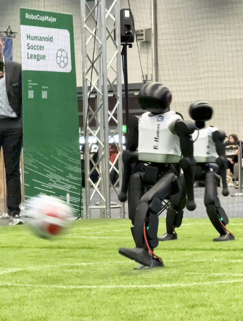 A B-Human robot kicks the ball.